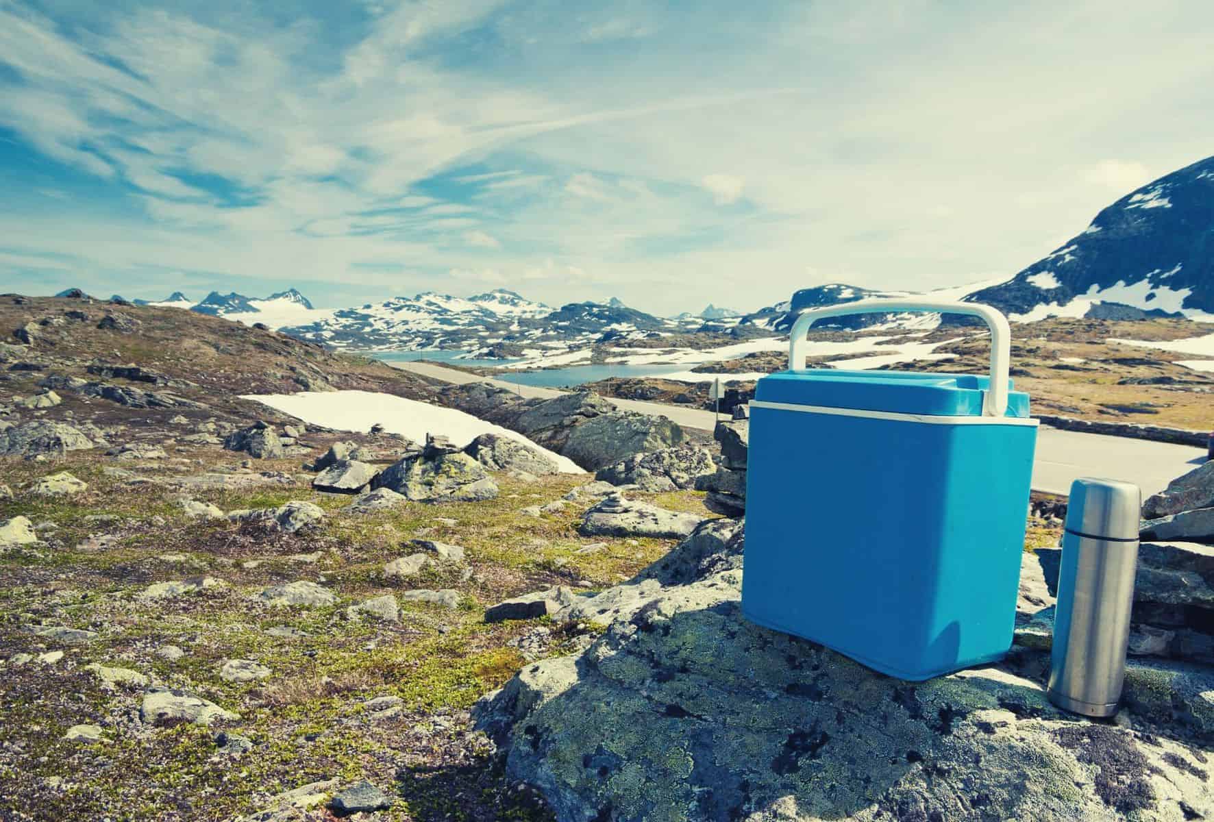 Cooler sitting on rocks in a mountaineous region