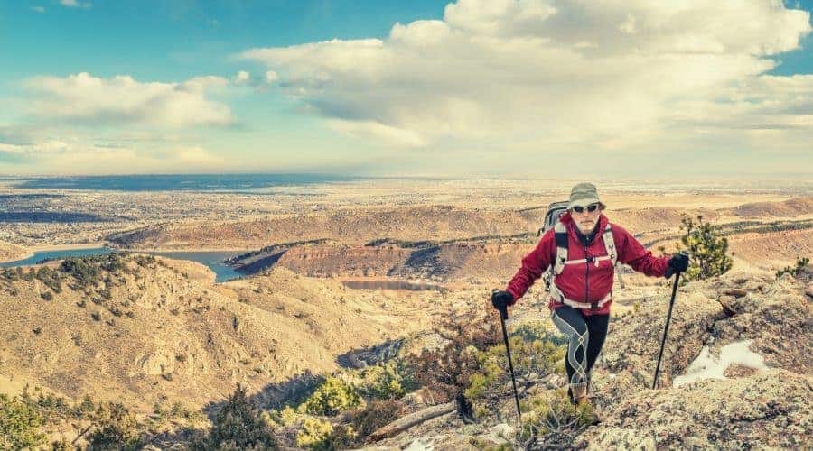 mature backpacker on a mountain ridge in hiking tights