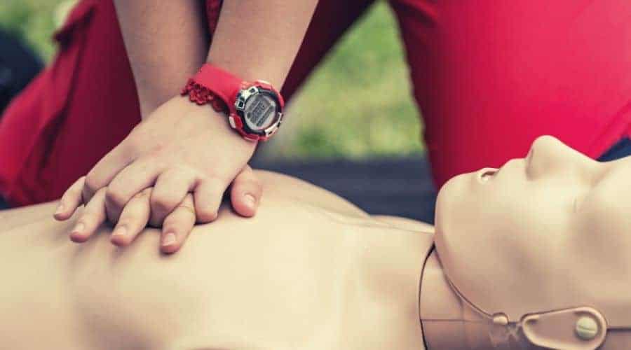 Cpr training outdoors. Reanimation procedure on CPR doll