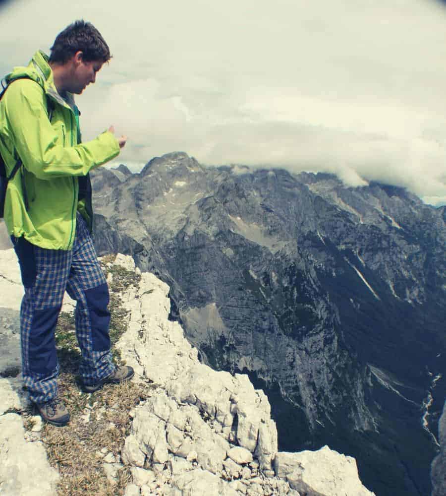 hiker overlooking cliff edge