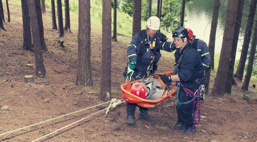 man on stretcher in forest