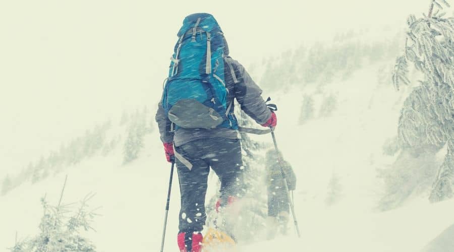 hikers on winter hike in deep snow intext