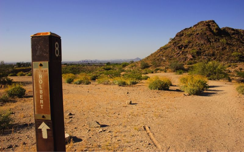 Holbert trail marker with Phoenix in the distance.
