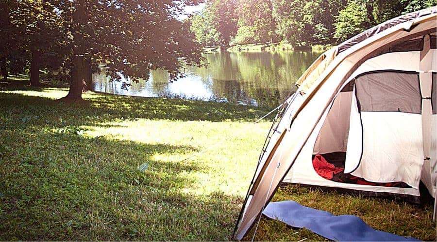 tent with screened porch by lake - In Text
