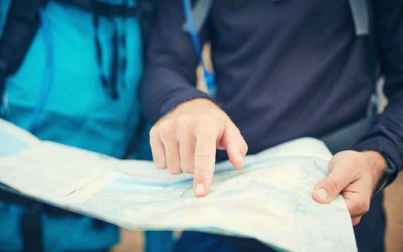 Two hikers reading a map