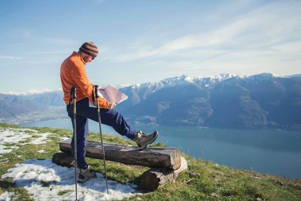 Man reading map on a mountaintop