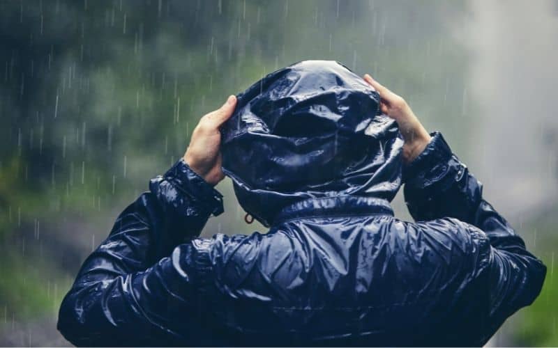 Man wearing drenched rain jacket in the rain