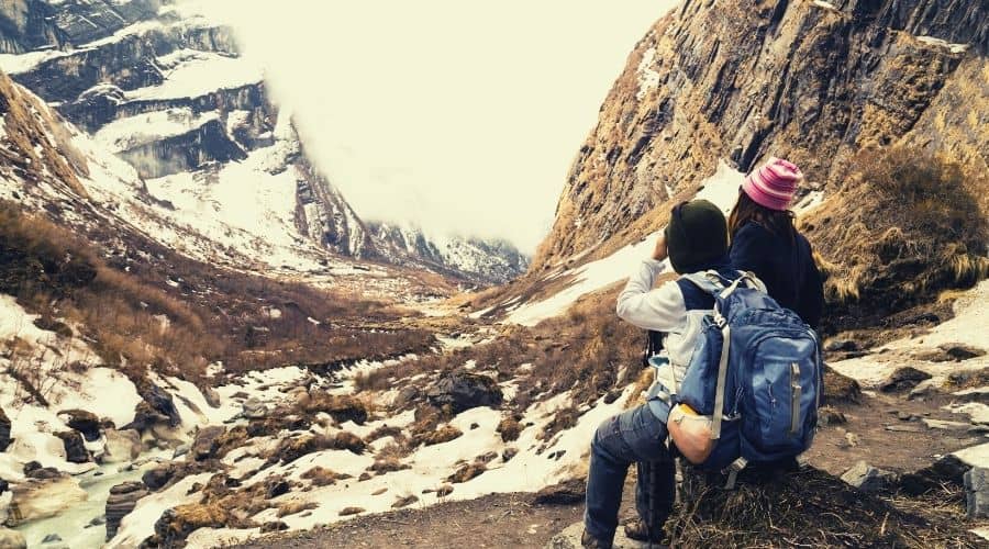 hikers resting in cold over scenic view