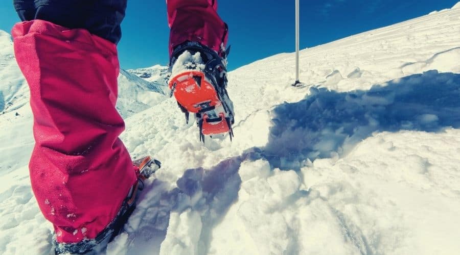 using gaiters and crampons on snowy mountain