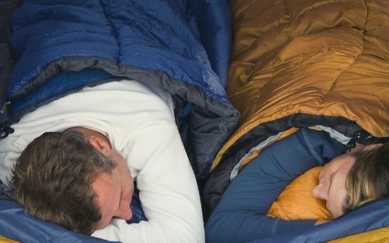 Couple sleeping in sleeping bags