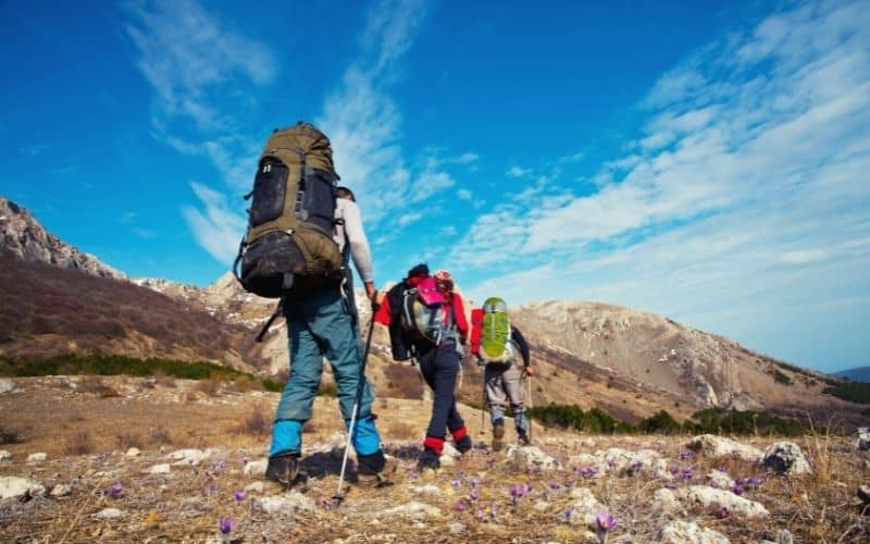 Hikers walking over flat rubbley ground