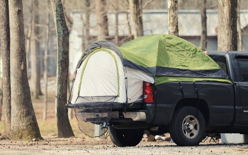 Truck bed tent setup in the back of a pickup truck
