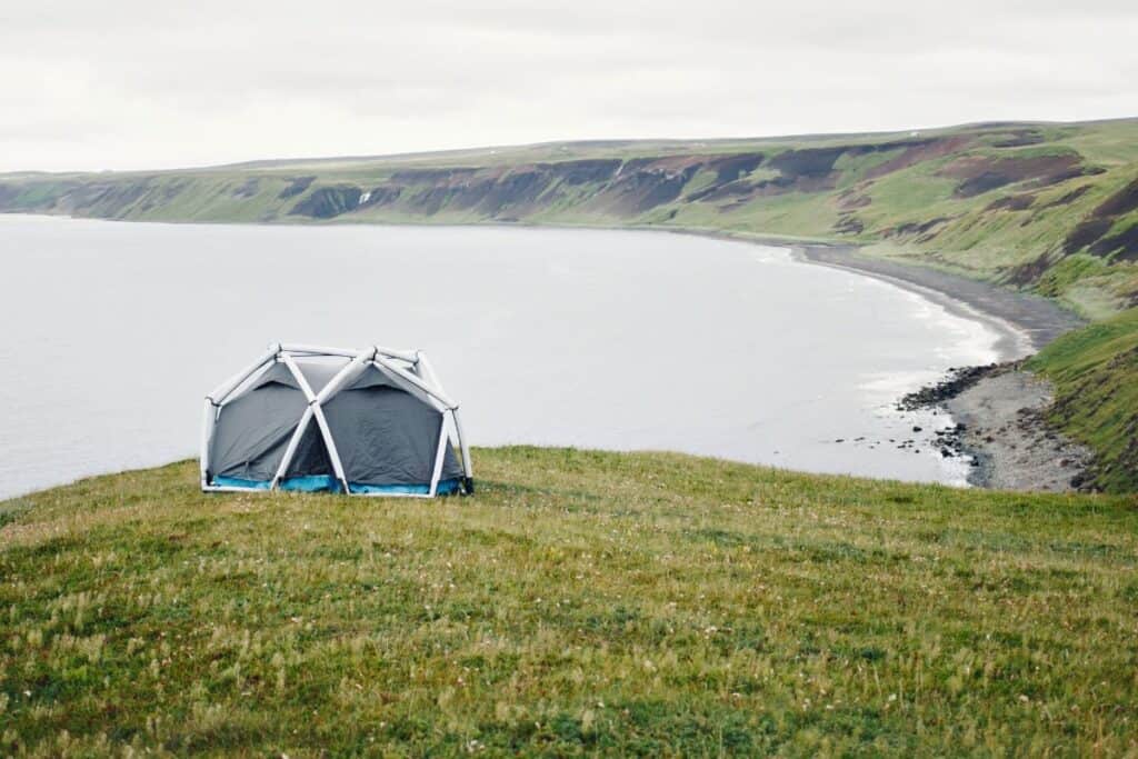 Inflatable tent pitched on cliff top overlooking the sea