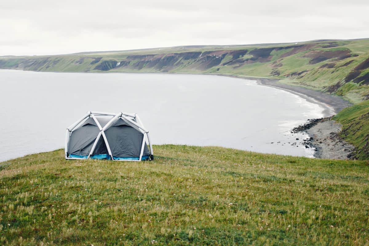 Inflatable tent pitched on cliff top overlooking the sea