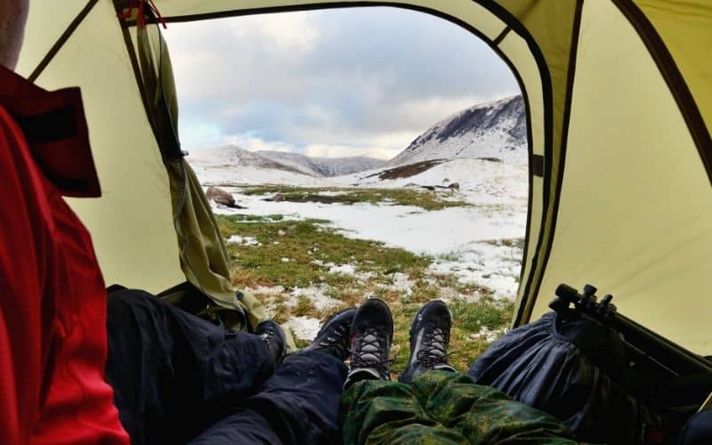 looking out at snowfield from tent