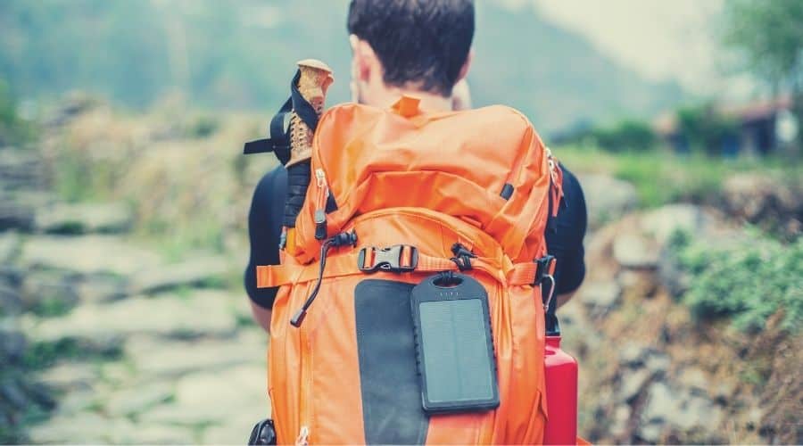 portable solar charger on backpackers backpack