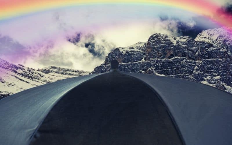 rainbow over umbrella and mountain