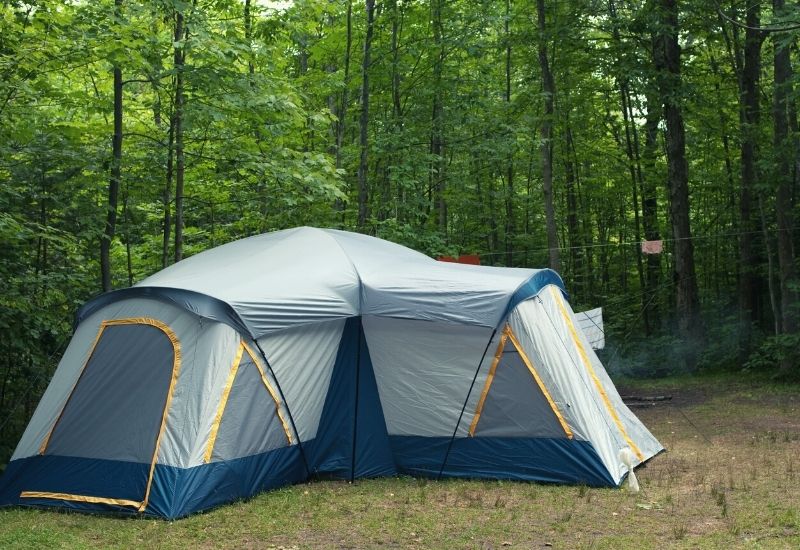 Large cabin tent pitched in the forest