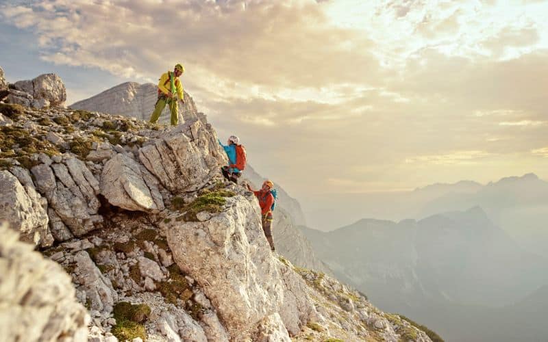 A group of mountaineers scaling a cliff face