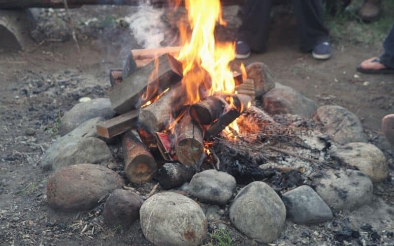 Campfire burning within the bounds of a campfire ring