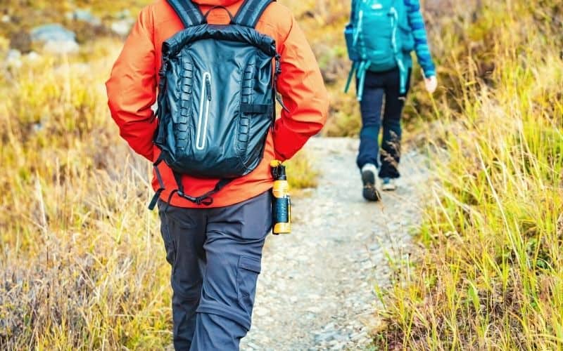 Hiker walking with bear spray attached to his hip