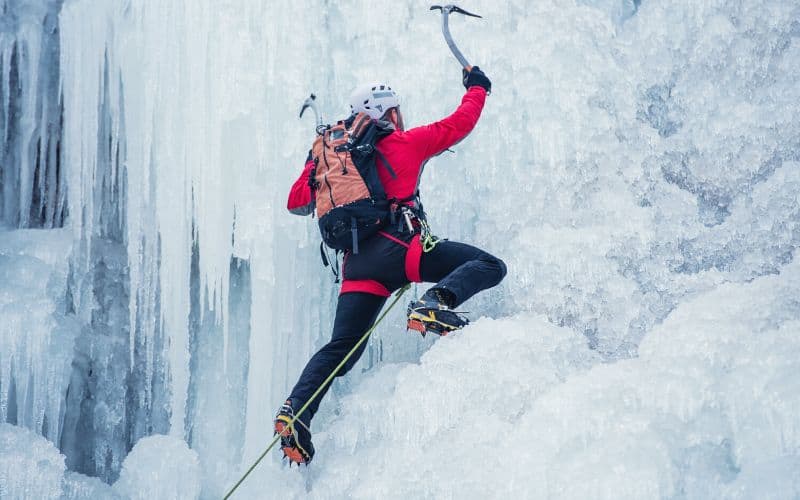 Ice climber traversing a frozen waterfall
