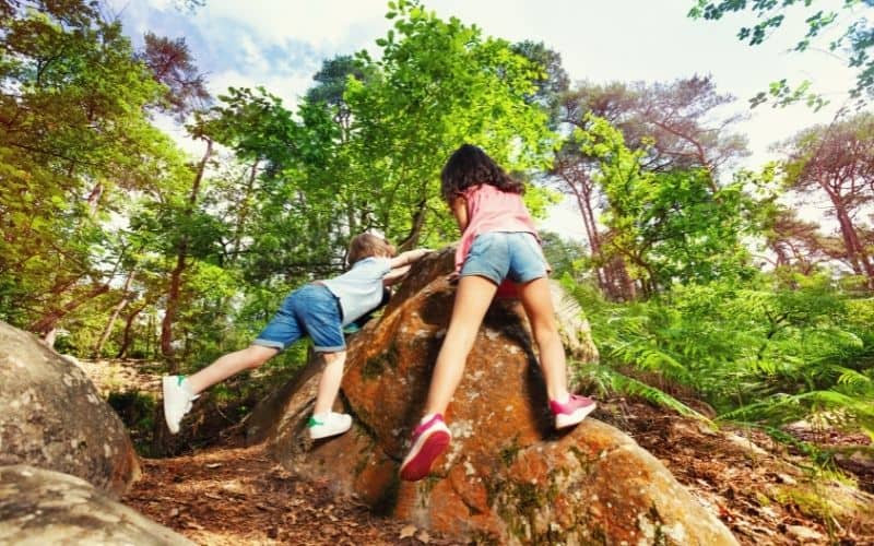 Kids climbing over rocks