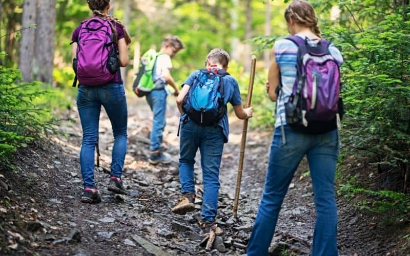 Kids hiking across uneven ground