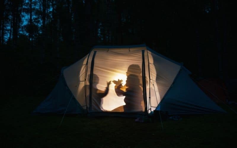 Kids making hand shadows in a tent