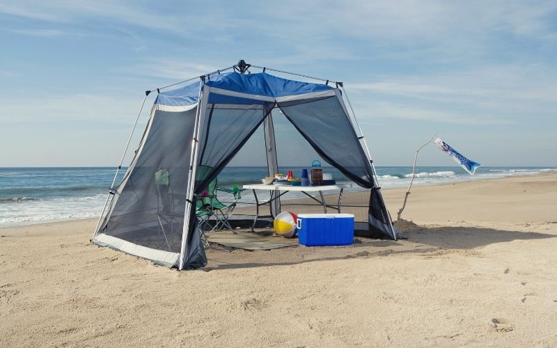 Pop-up canopy with mesh walls pitched on a beach