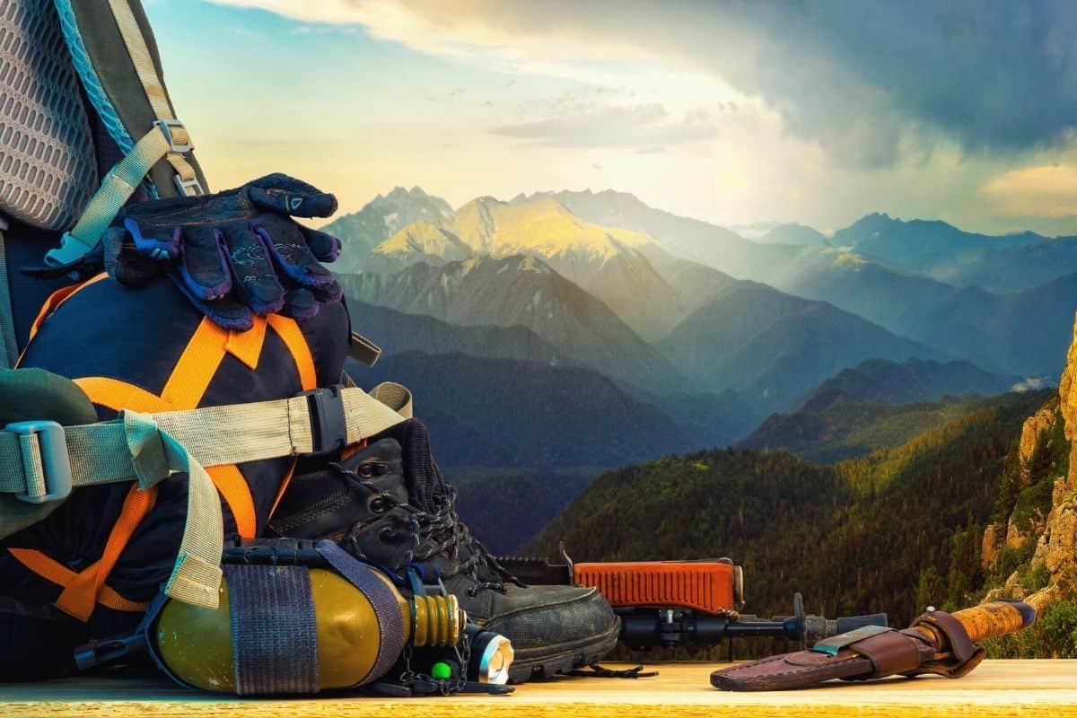 Backpacking gear sitting in front of a mountain