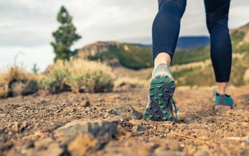 female hiker in leggings on trail