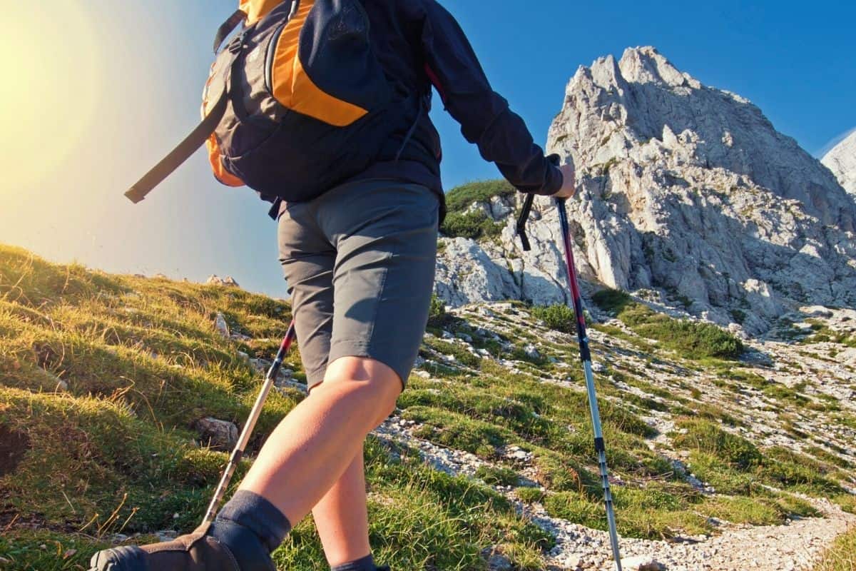 Man hiking up mountain in the sun