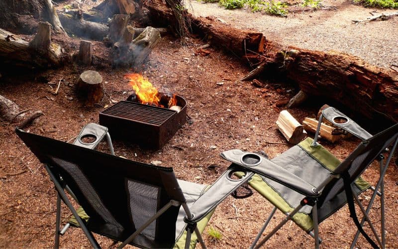 Two camp chairs around a camp fire