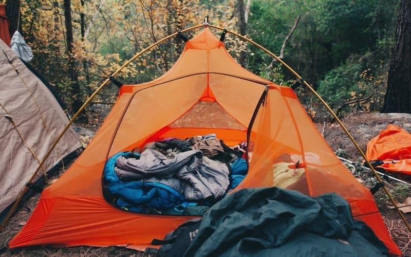 mess of sleeping bags, pillows and clothes in backpacking tent