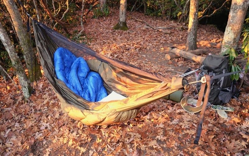 sleeping bag and backpacking pillow in camping hammock
