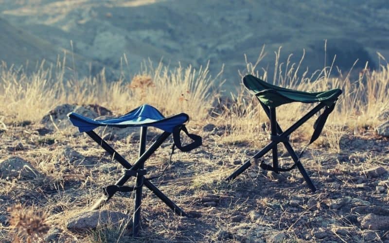 two backpacking stools overlooking valley