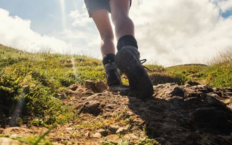 Close up of hiking boots on hiker going uphill