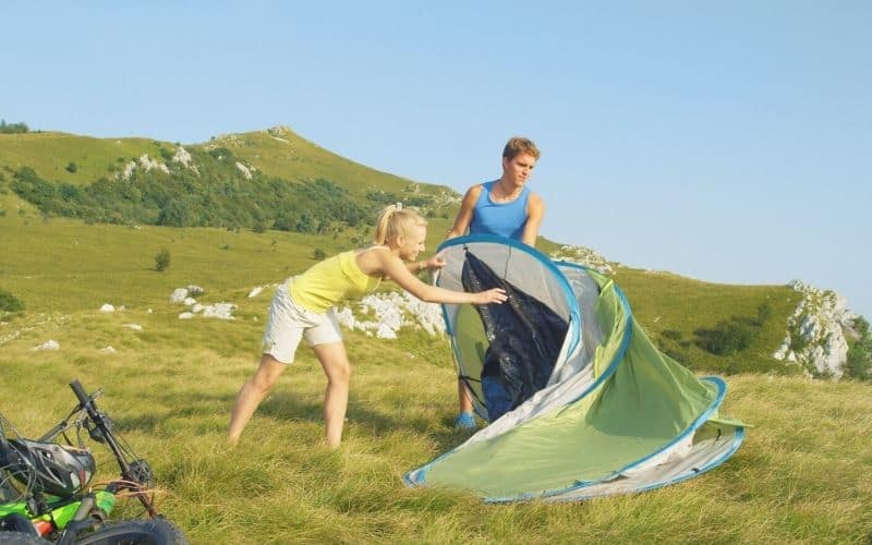 Couple setting up a pop-up instant tent