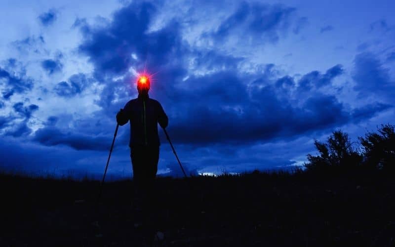 Hiker wearing red head lamp