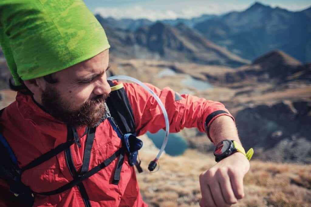 Man looking at his GPS tracker on his hiking watch
