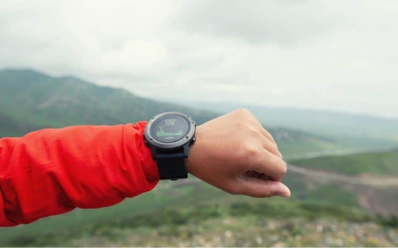 Hiker checking altitude on his hiking watch