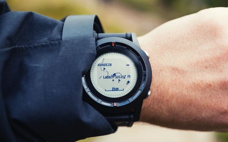 Man wearing  hiking watch looking at a GPS map