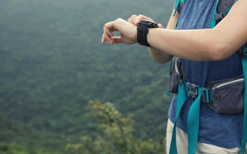 Woman looking through features on her hiking watch 