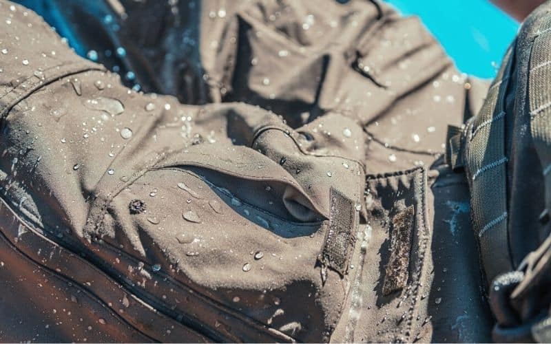 Water beading up on surface of DWR coating on rain pants