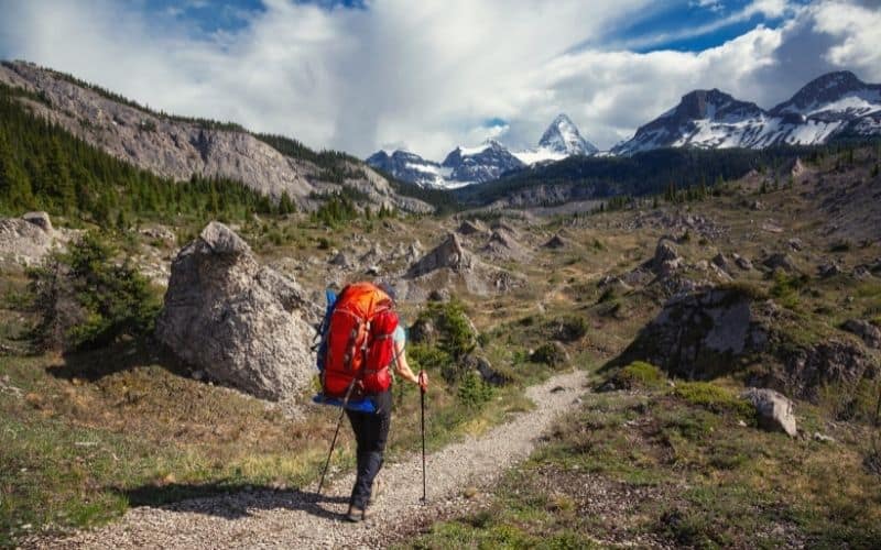 Backpacker walking along trail near Banff Canada