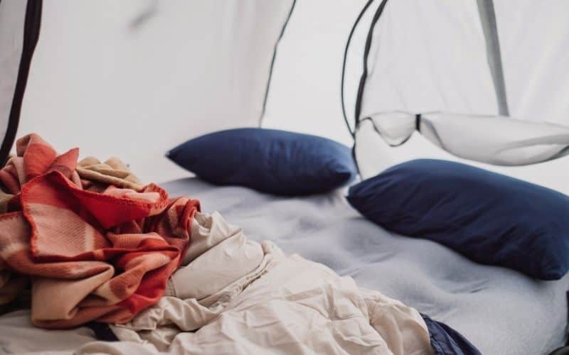 Double inflatable mattress and bedding inside a tent