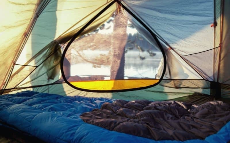 Sleeping bag laid flat inside tent