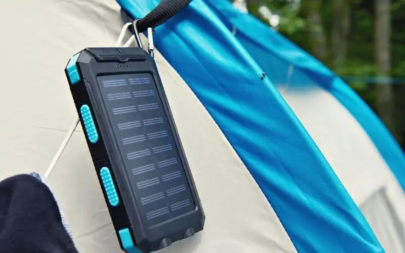 Solar power pack attached to tent charging in the sun