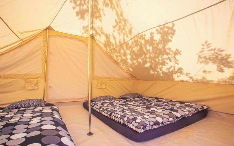 Two double camping mattresses inside a tent